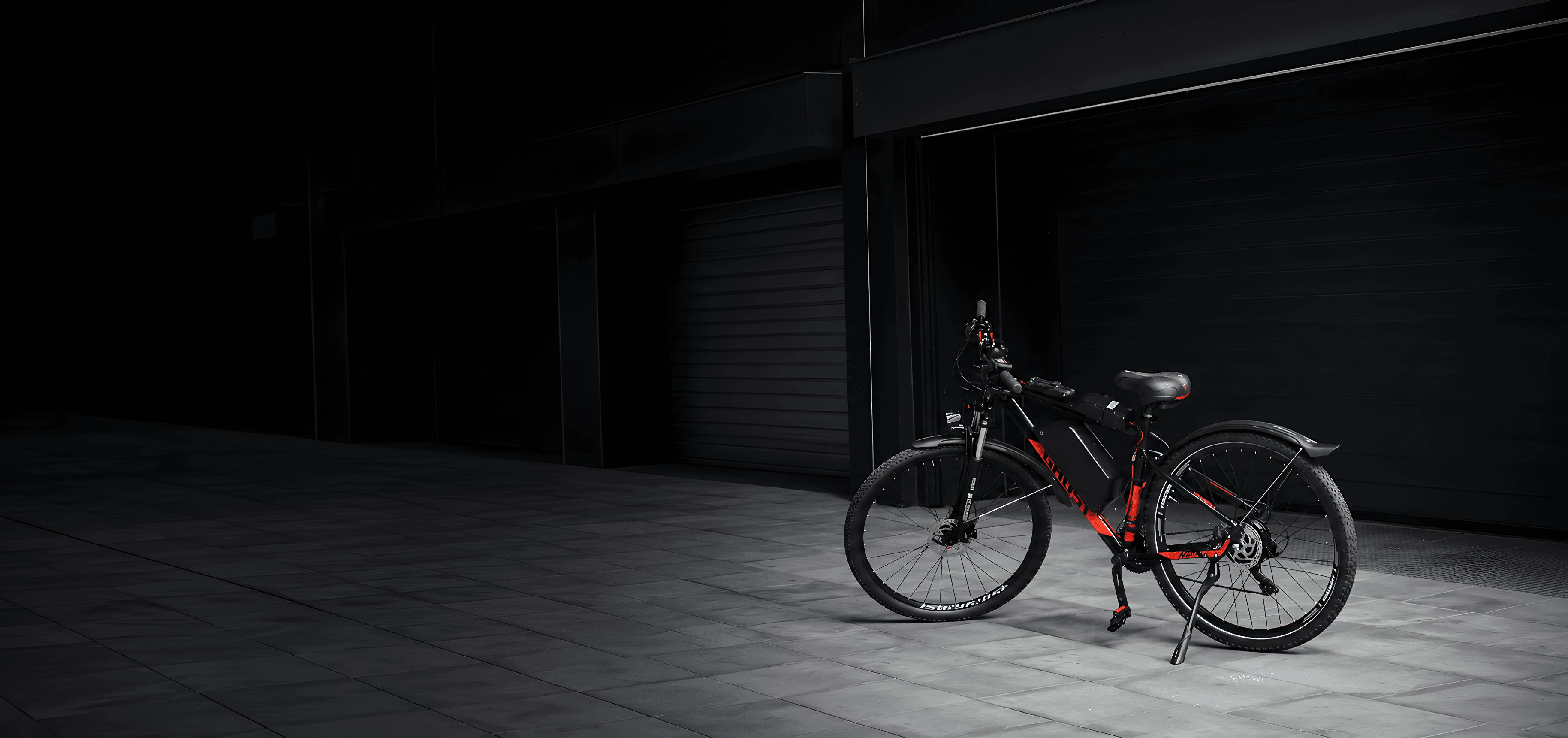 Electric bike parked in front of an industrial garage at night